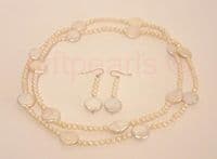 Large coin-shaped pearls on a 36 inch string of small round pearls.