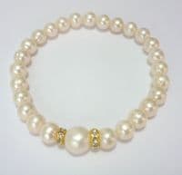 Pearl bracelet with featured 10 mm pearl and rhinestone spacers.