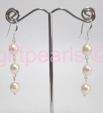 Triple pearl drop ear-rings on silver hooks.
