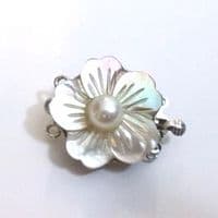 Two-Strand oval button pearls with carved shell clasp.