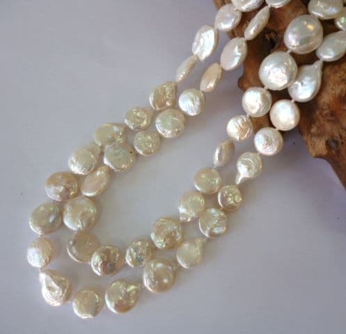 Two-Strand oval button pearls with carved shell clasp.