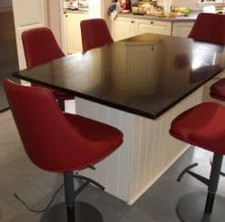 ^ Glamour S Stools in Burgundy Leather around a kitchen Island