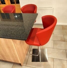 3 Ines Adjustable Bar Stools grouped around a kitchen island