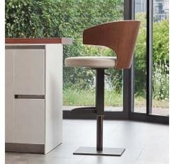 A Wing Bar Stool with Wood Back at a Kitchen Counter 