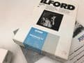 Various boxes of black and white Ilford photographic paper