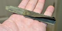 A huge Late Medieval bronze strap end with remnant of leather strap still attached, Yorkshire SOLD