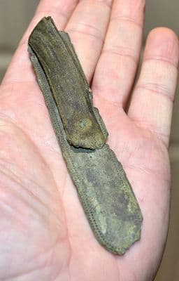 A huge Late Medieval bronze strap end with remnant of leather strap still attached, Yorkshire SOLD