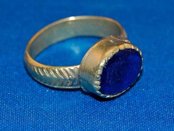 A large 18th/19th Century pleasant Islamic silver gents finger ring with a blue glass / gem stone set bezel.