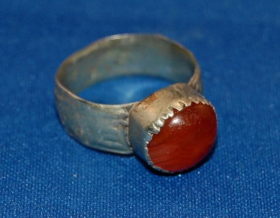 A large 18th/19th Century pleasant Islamic silver gents finger ring with a Carnelian gemstone set bezel. SOLD