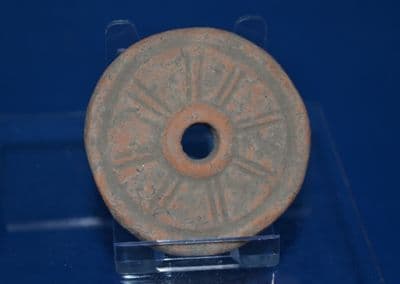 A large and rare redware Roman terracotta wheel from a childs pull along toy chariot, London. SOLD