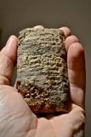 A large and rare Sumerian bi-facial baked clay tablet featuring many lines of Cunieform [Cuneiform] script (Repaired) SOLD