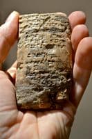 A large and rare Sumerian bi-facial baked clay tablet featuring many lines of Cunieform [Cuneiform] script (Repaired) SOLD