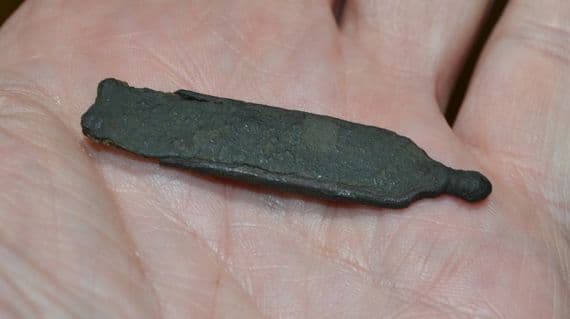 A large Medieval Bronze Strap end with some original strap within, Norfolk