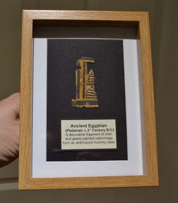 A nicely framed fragment of painted cartonnage from an Ancient Egyptian anthropoid sarcophagus. SOLD