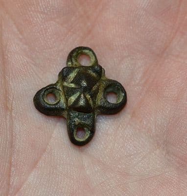A pleasant and unusual Anglo Saxon embossed bronze four way decorative mount, Kent. SOLD