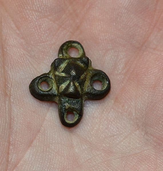 A pleasant and unusual Anglo Saxon embossed bronze four way decorative mount, Kent. SOLD