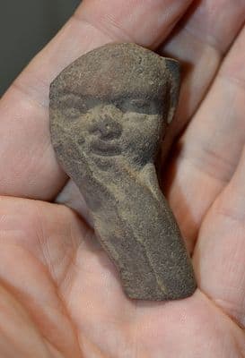 A pleasant Ptolemaic period Ancient Egyptian terracotta face from a votive figure of the infant Horus