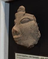 A pleasantly mounted facial segment from a large Ancient Egyptian wooden votive statuette. SOLD