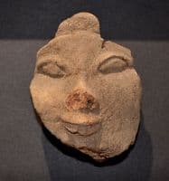 A pleasantly mounted facial segment from a large Ancient Egyptian wooden votive statuette. SOLD