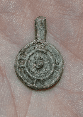 A rare and unusual Anglo Saxon decorative lead disc shaped pendant found near Brentwood, Essex. SOLD