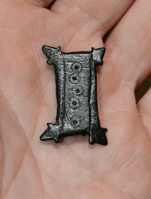 A rare and unusual early Anglo Saxon rectangular bronze plate brooch with punched and inscised decoration, found in Hertfordshire. SOLD