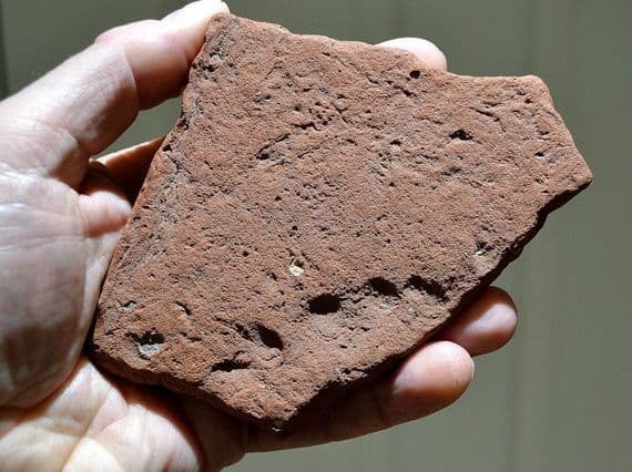 A rare segment of Roman terracotta roof tile featuring a childs fingerprints (K2)