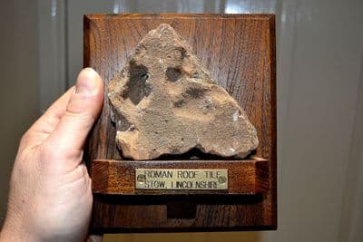 A rare segment of Roman terracotta roof tile with a  dogs paw print, on a vintage mount, Lincs. SOLD