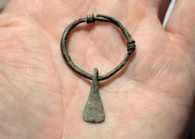 A scarce and excellent Celtic bronze Axe pendant on its original suspension hoop. SOLD