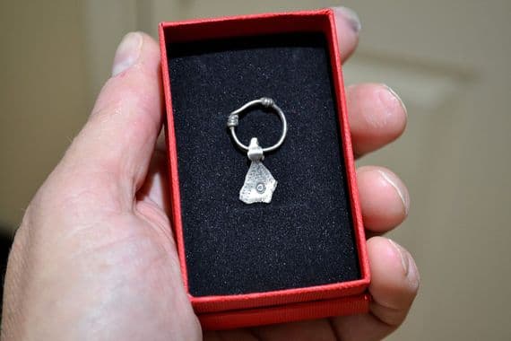 A scarce and unusual Viking silver axe pendant on its original suspension loop, Eastern Europe. SOLD