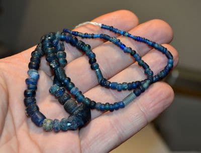 A very attractive re-strung group of Roman blue glass necklace beads (46cm / 19 inch approx)