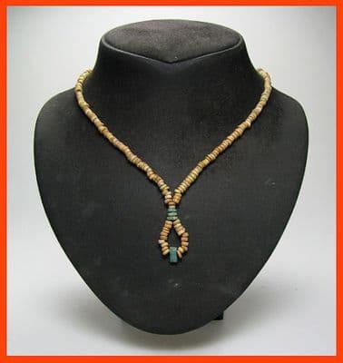 An attractive restrung necklace of Ancient Egyptian multicoloured Faience beads, drop design at base containing amulet, modern twist clasp. SOLD