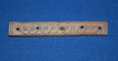 An expertly carved and decorated main body section from a Roman bone hair comb, London. SOLD