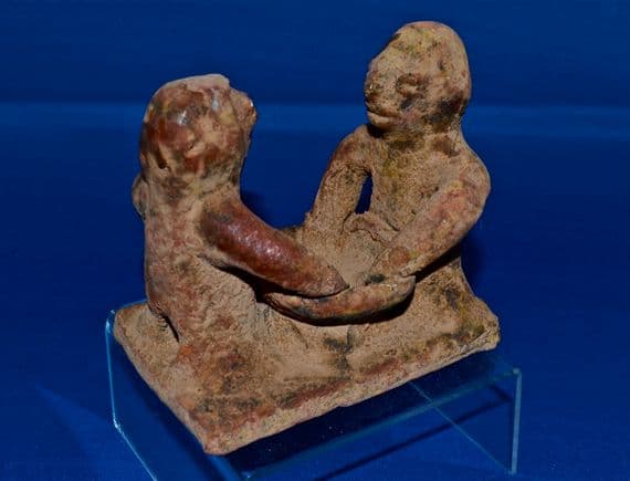 An extremely rare Pre-classic period Mayan pottery figurative oil lamp. SOLD