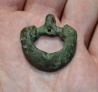 An unusual and sizable Anglo Saxon bronze buckle featuring the heads of two beasts, Yorkshire. SOLD