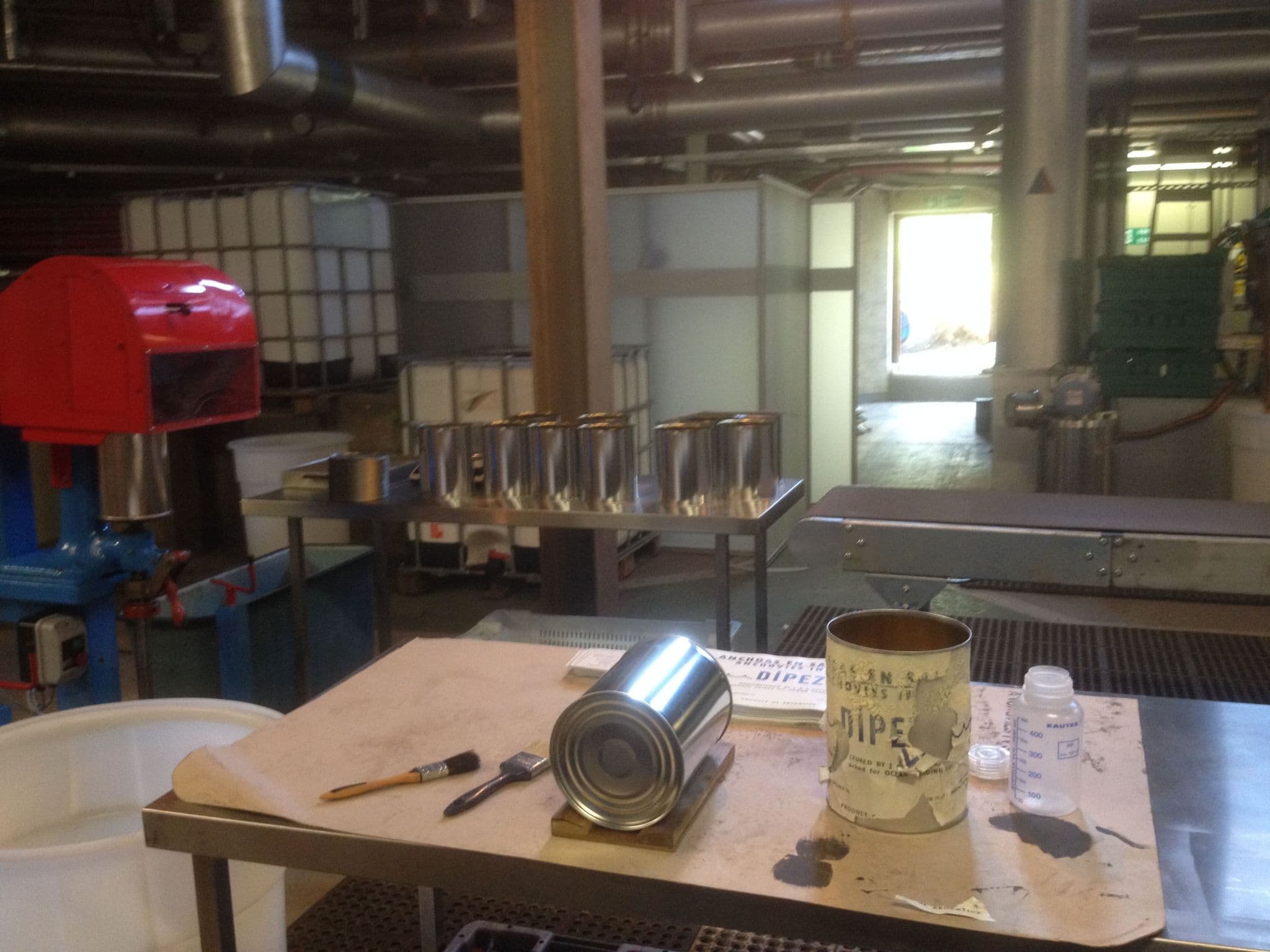 Tin cans and seaming equipment prepared for use in a film production