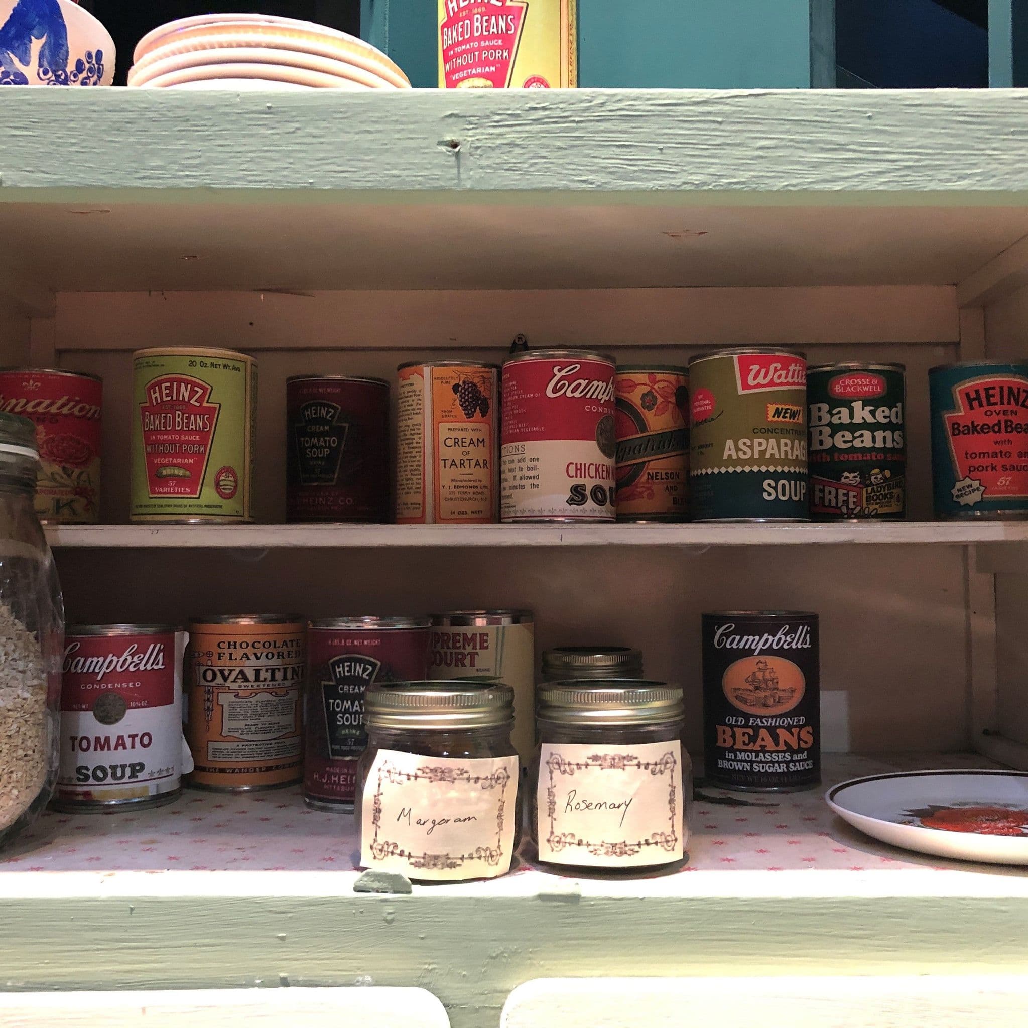 Replica tins with period-appropriate labels used as set dressing in a Royal College of Music Opera Studio production