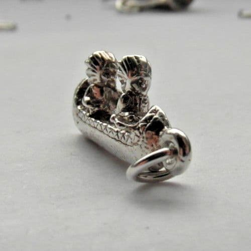 native Americans sailing a canoe vintage silver charm for a charm bracelet