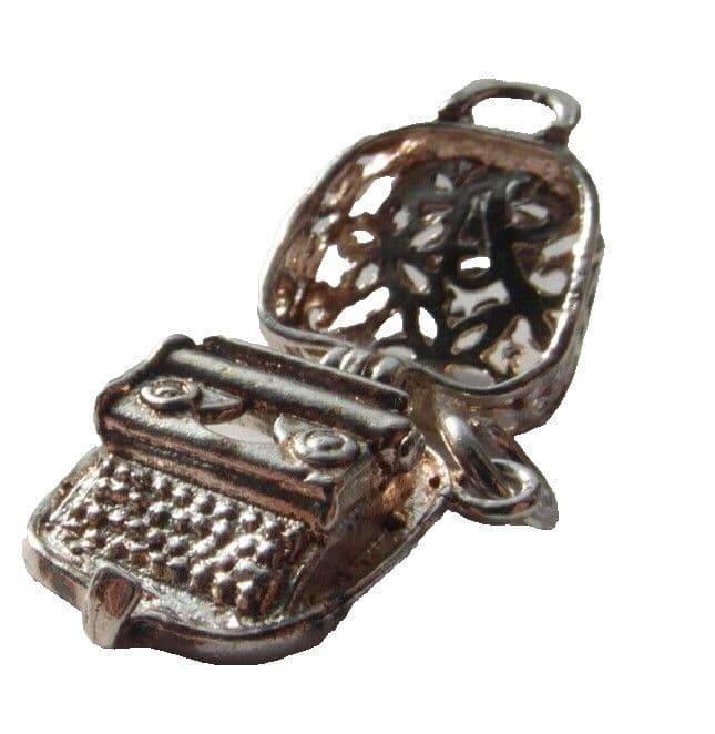 old vintage silver charm of a typewriter in a case for a charm bracelet