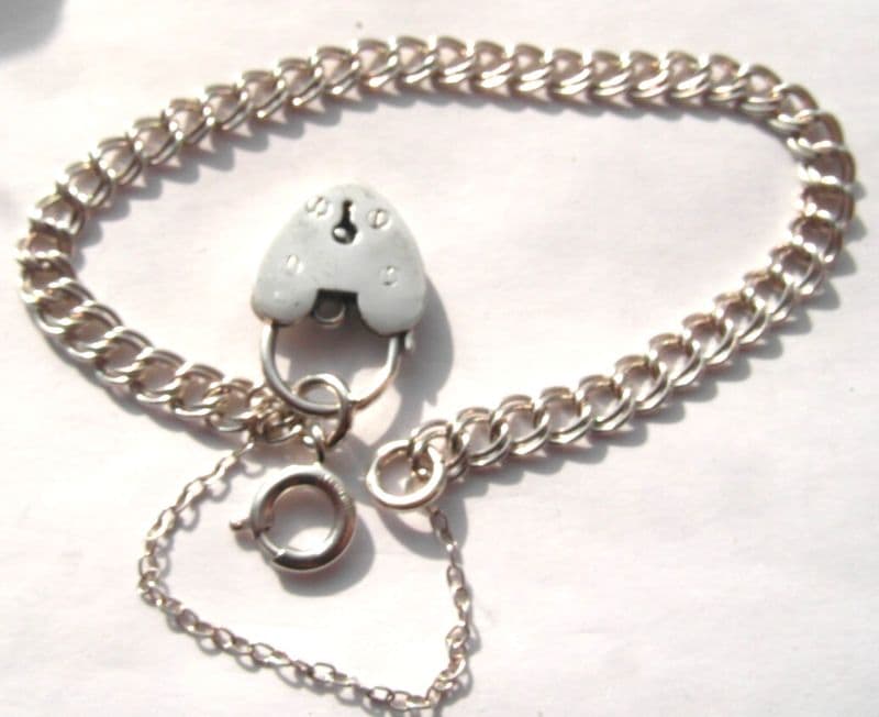 traditional vintage silver charm bracelet complete with a heart padlock