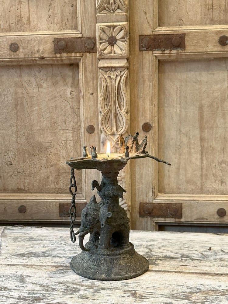 antique bronze candle holder with an elephant and peacocks