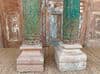 Decorative teak pillars with green paint tones & sandstone bases, circa 1890, Gujarat