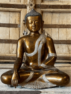 gold and silver plated bronze buddha in meditation with hand mudras in the bhumisparsha pose