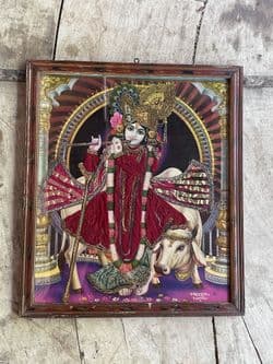 Tanjore painting depicting Lord Krishna God of Love, seated on a holy cow