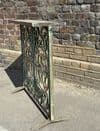 vintage iron console with faded paint tones and inset marble top