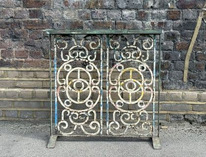 vintage iron console with faded paint tones and inset marble top