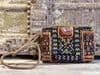 vintage textile bag with coin and cowrie shell embellishment