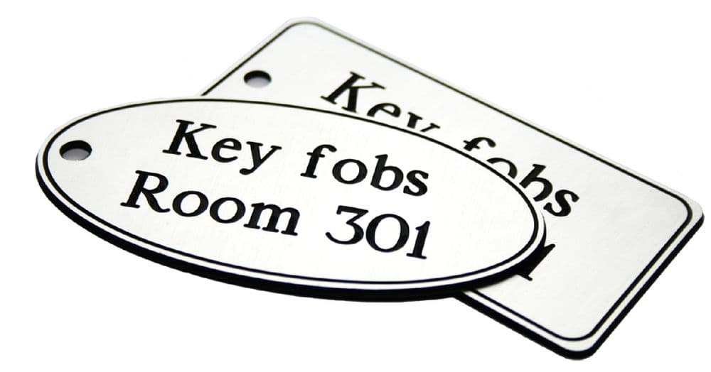 51531 50x100mm Key fob oval - White text on black 50x100mm Safety Sign