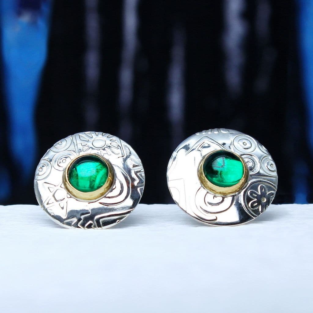 A pair of sterling silver round ear studs featuring green spinel gemstones and an embossed pattern