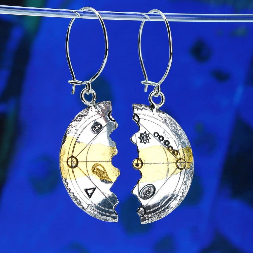 A pair of Keum boo silver and 24 carat gold earrings cut into halved circles and featuring embossed stamps and shapes