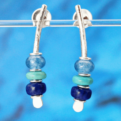 Beautiful handmade sterling silver earrings featuring blue gemstones. Small arc earrings.